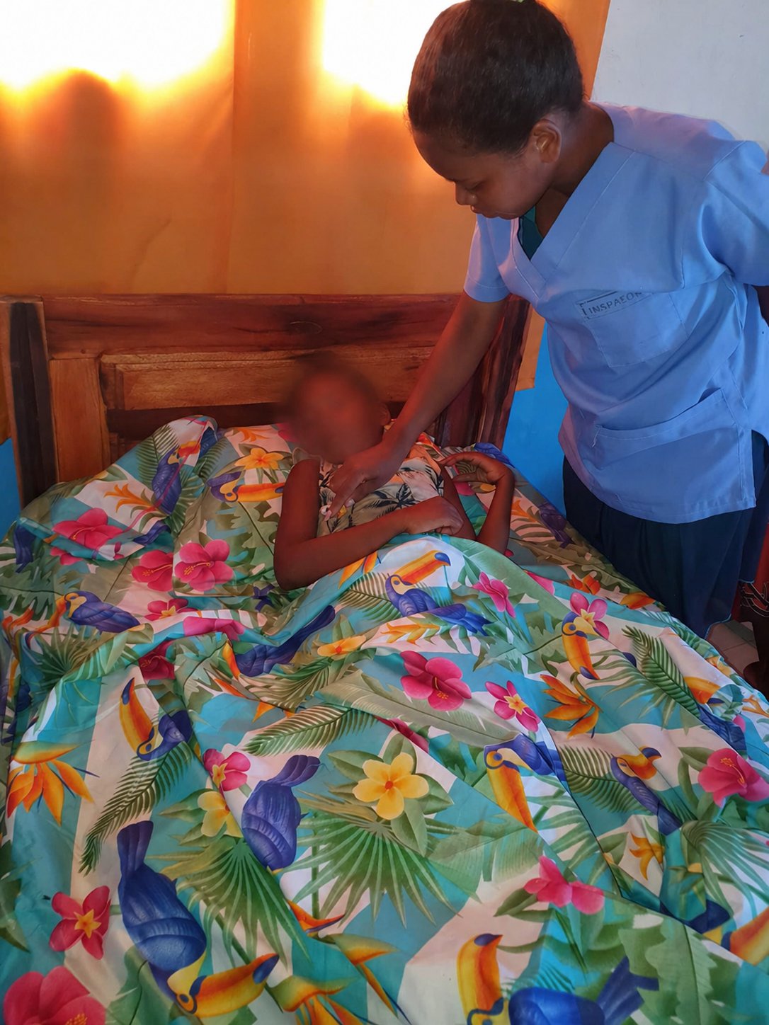 A nurse providing care to an adolescent resident at Ny Trano Manga.